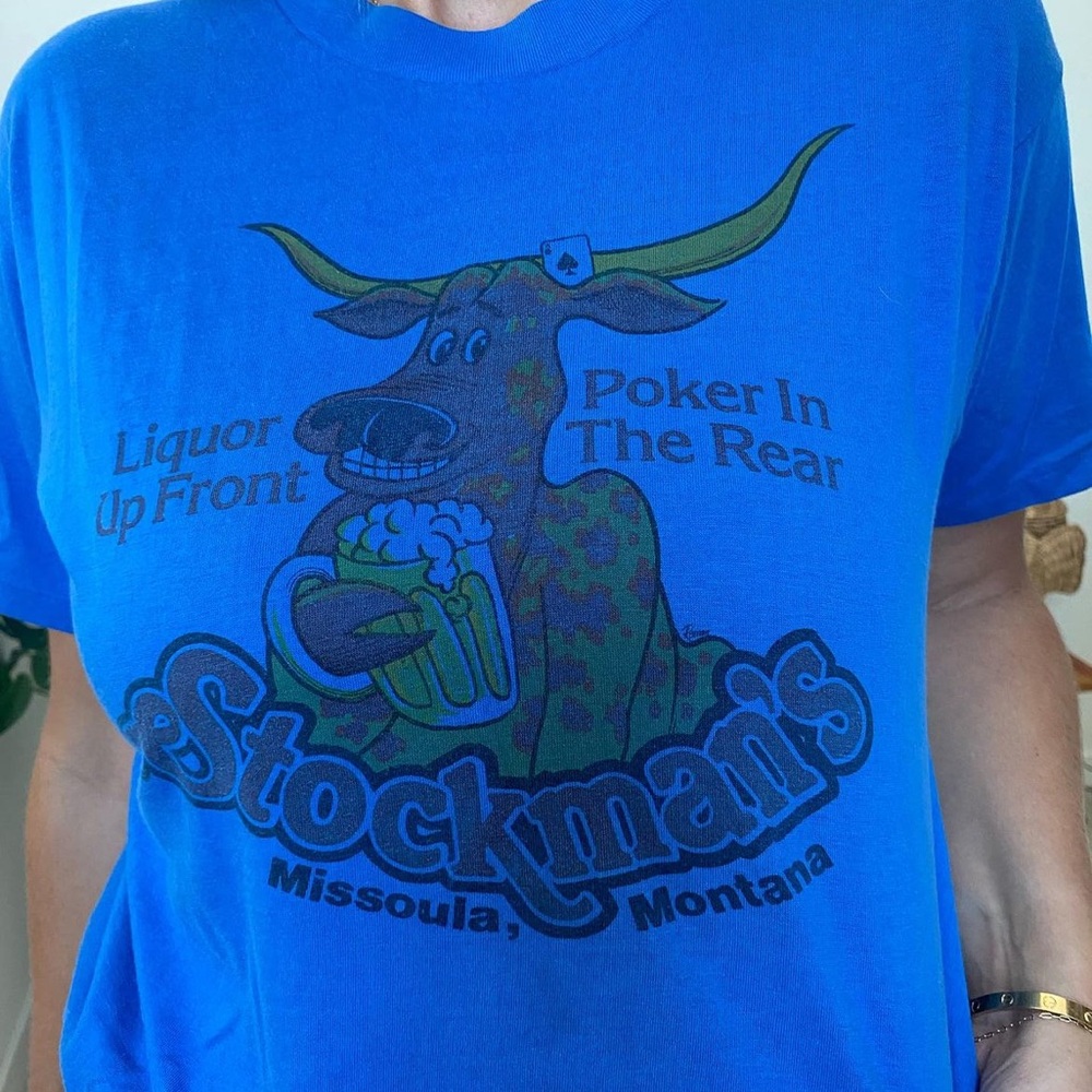Blue short sleeve cheeky tee. Liquor up front, Poker in the rear